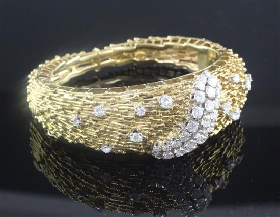 An 18ct yellow gold and diamond hinged bangle, of rod and sphere design, gross weight 59.3 grams.